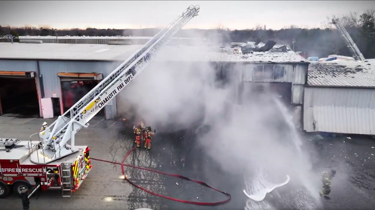Firefighters put out a two-alarm fire at a warehouse where a tanker trailer caught fire Tuesday morning.