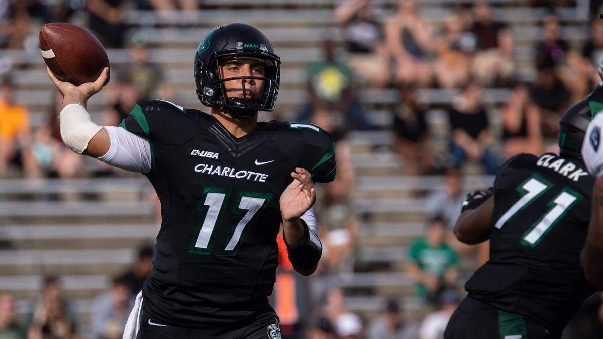 Charlotte 49ers quarterback Chris Reynolds gets the attention, but it tackle Cameron Clark (71) who throws the block. Clark is part of an unheralded offensive line that is getting healthy for the first time and leading a 49ers’ offensive surge.