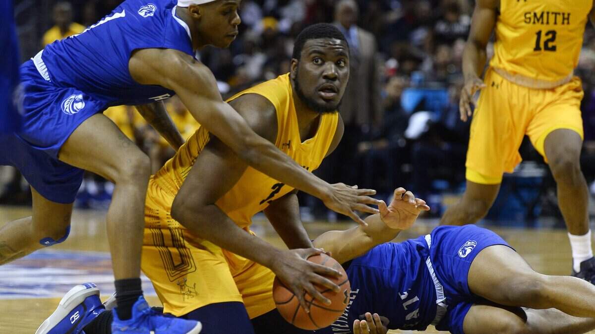 Johnson C. Smith’s Frederick Gallaway (31) tries to pass the ball past Fayetteville State’s Jalen Spicer (1) during the first half of their semi-final game in the 2020 CIAA Tournament at the Spectrum Center on Friday, February 28, 2020.