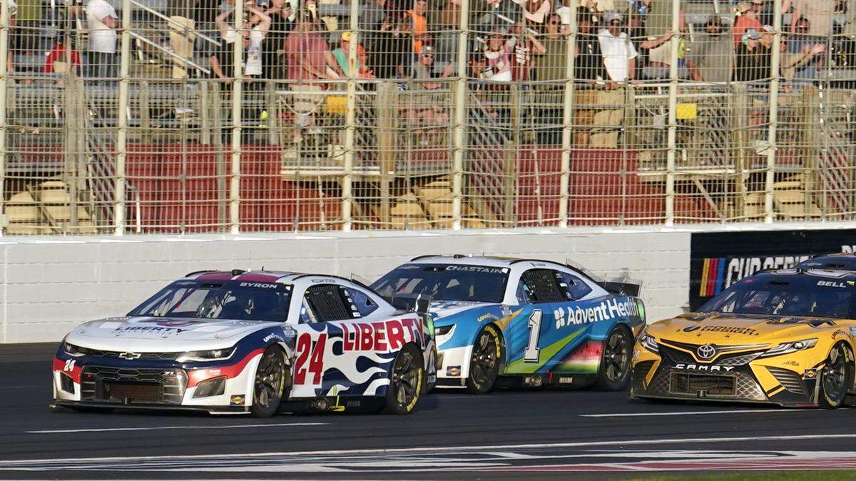 William Byron (24) races Ross Chastain (1) and Christopher Bell (20) to the finish line to win a NASCAR Cup Series auto race at Atlanta Motor Speedway in Hampton, Ga., Sunday, March 20, 2022, (AP Photo/John Bazemore)