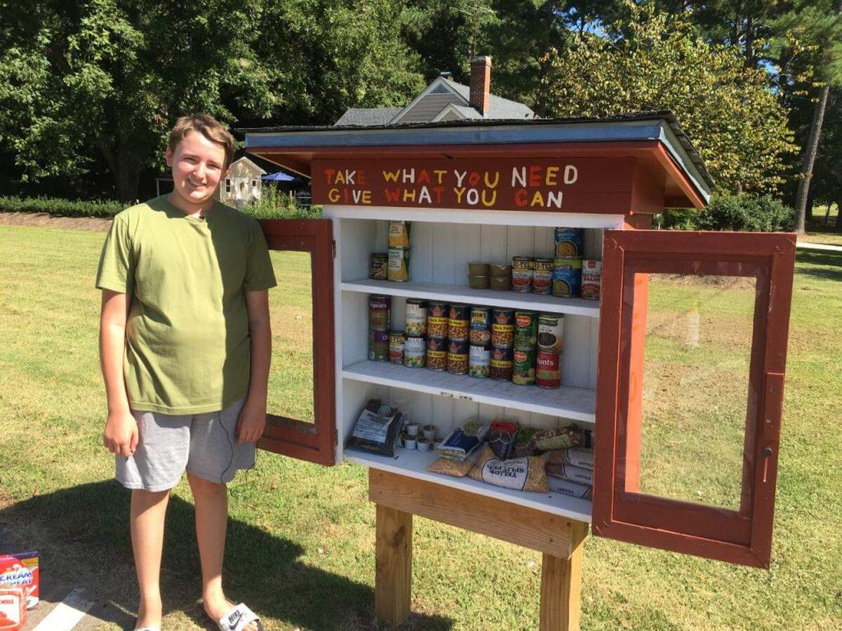Luke Tingler, 13, next to the Little Free Pantry he created as part of his church confirmation in Spring Hope, Nash County.