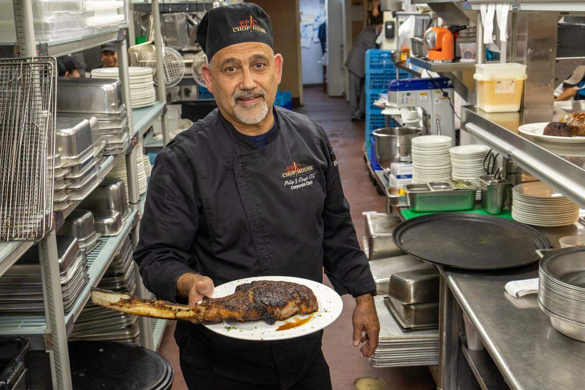 Corporate executive chef Philip Lloyd holds an Epic 48-ounce long-bone Tomahwk ribeye.