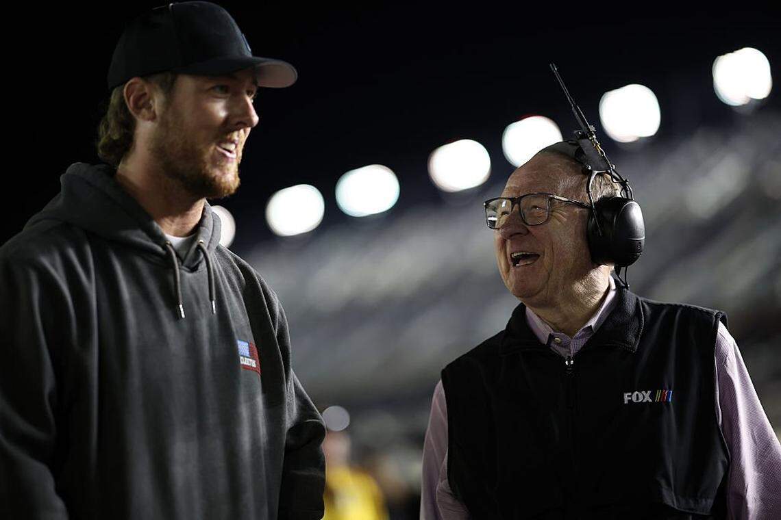 Garrett Mitchell, also known as Cleetus McFarland, left, and NASCAR Fox analyst Larry McReynolds talk during qualifying for the NASCAR Cup Series Daytona 500 at Daytona International Speedway on Feb. 11, 2026, in Daytona Beach, Florida.
