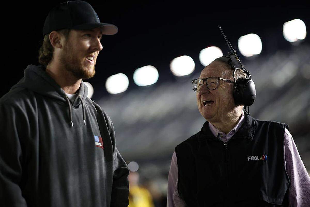 DAYTONA BEACH, FLORIDA - FEBRUARY 11: Garrett Mitchell, also known as Cleetus McFarland (L) and NASCAR Fox analyst, Larry McReynolds talk during qualifying for the NASCAR Cup Series Daytona 500 at Daytona International Speedway on February 11, 2026 in Daytona Beach, Florida. (Photo by James Gilbert/Getty Images)