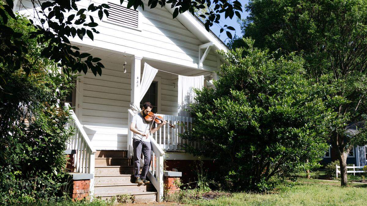 Charlotte Symphony Orchestra principal violist Ben Geller plays on the steps of his home.