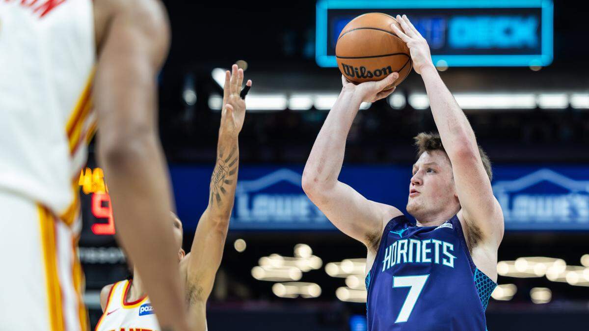 Charlotte Hornets guard Kon Knueppel, right, shoots past a block by Atlanta Hawks forward Zaccharie Risacher at the Spectrum Center in Charlotte, N.C., on Wednesday, February 11, 2026.