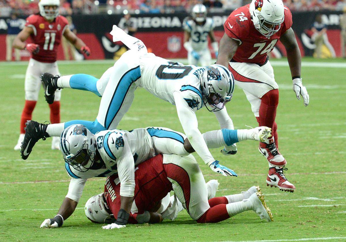 Carolina Panthers linebacker Brian Burns, center, sacks Arizona quarterback Kyler Murray, bottom, on Sept. 22nd. Burns, 21, is the youngest Panther on the team’s roster.