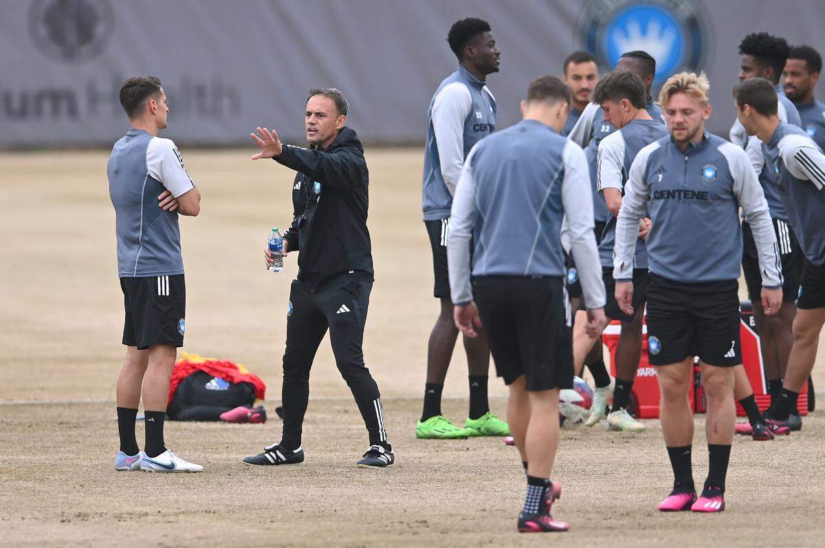 Charlotte FC head coach Christian Lattanzio, center, speaks with midfielder Ashley Westwood, left, prior to practice on Wednesday, February 22, 2023.