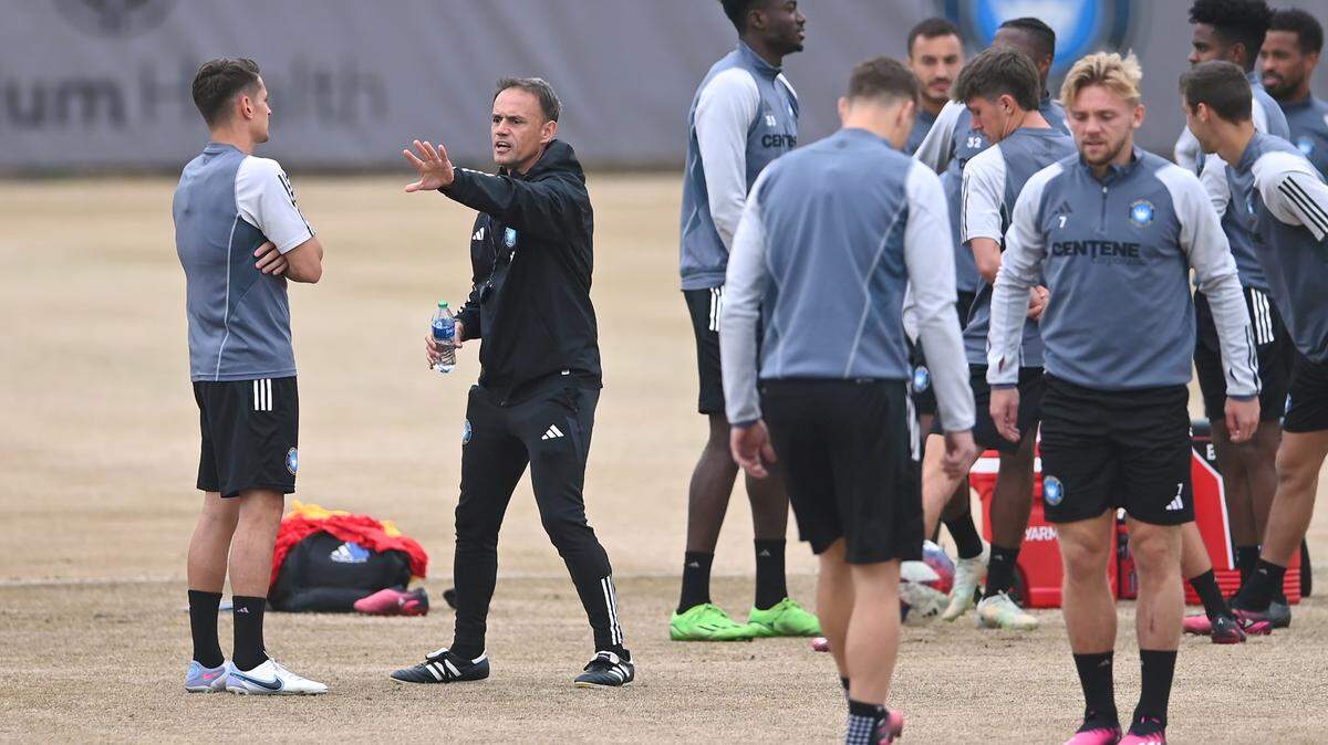 Charlotte FC head coach Christian Lattanzio, center, speaks with midfielder Ashley Westwood, left, prior to practice on Wednesday, February 22, 2023.
