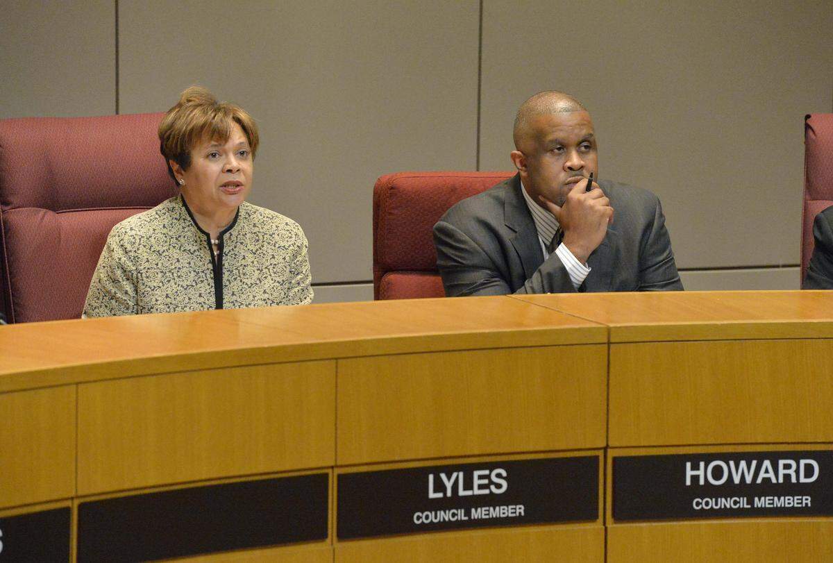 Council member Vi Lyles (left),David Howard (right), Lyles speaks to the audience,  during Monday night's city  council meeting held at the Government Center. 
