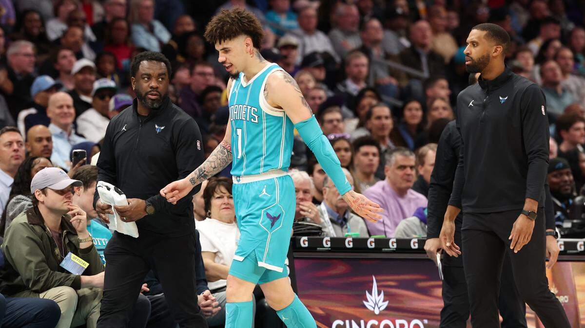 Charlotte Hornets guard LaMelo Ball, center, gingerly walks past the team’s bench to the locker room after falling to the court as he backpedaled downcourt. Ball tripped over Los Angeles Lakers forward Jarred Vanderbilt and leave the game with a sprained left ankle during action at Spectrum Center in Charlotte, NC on Monday, January 27, 2025.