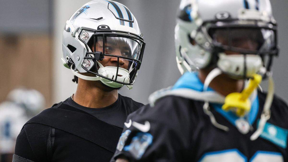 Panthers cornerback CJ Henderson, left, during the stretch period on day two of mini camp on Wednesday, June 15, 2022 in Charlotte, NC.
