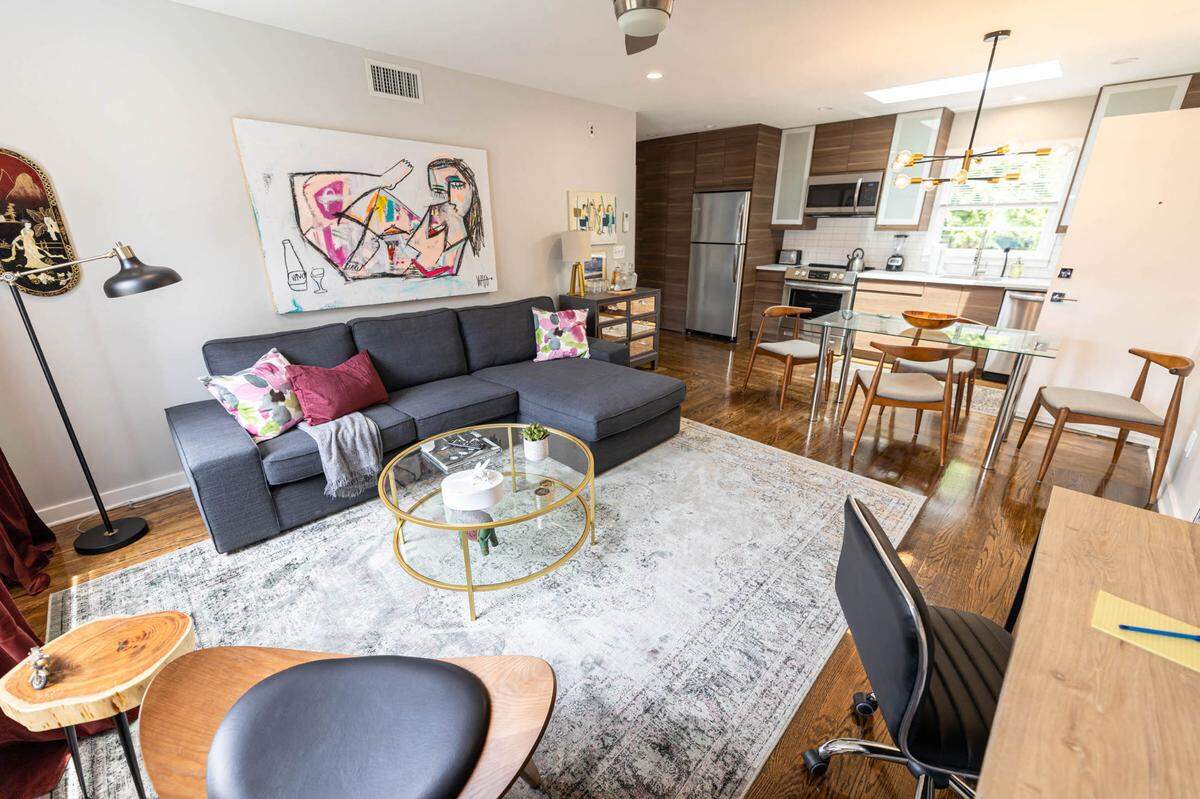 Each living room at The Home Collection’s 510 Queens Road building has a painting by Nico Amortegui hanging over the couch.