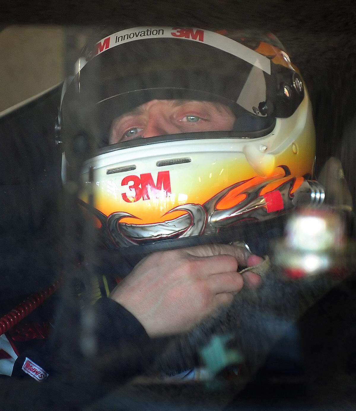 NASCAR driver Greg Biffle tightens his helmet before leaving the garage for practice at Daytona International Speedway in Daytona Beach, Florida, Friday, February 13, 2009. 