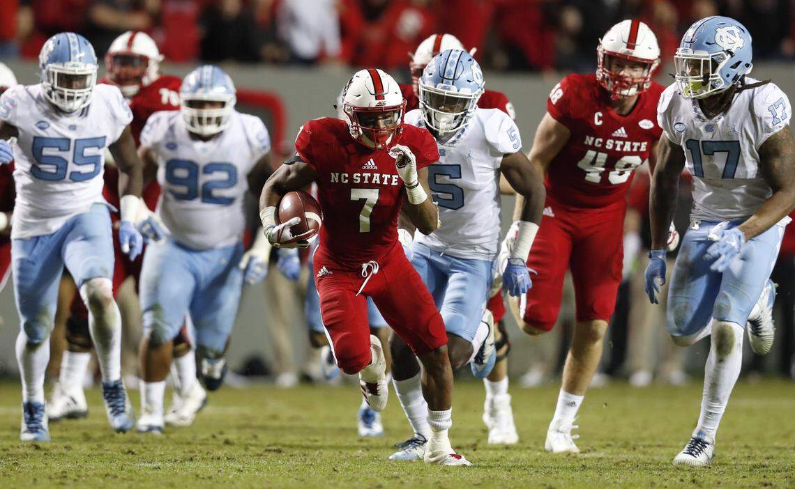 N.C. State Nyheim Hines (7) outruns the North Carolina defense on his way to scoring on a 48-yard touchdown during the second half of N.C. State’s 33-21 victory over UNC at Carter-Finley Stadium in Raleigh, N.C., Saturday, Nov. 25, 2017.