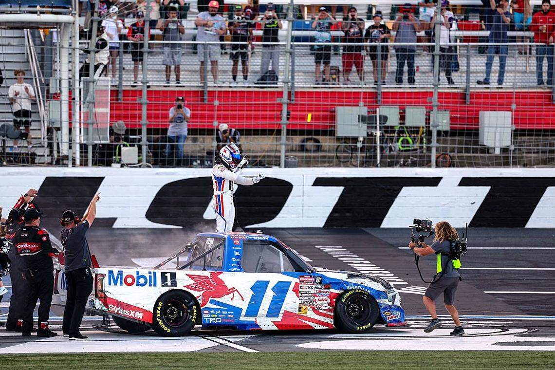 Corey Heim, driver of the #11 Mobil 1 Toyota, celebrates after winning the NASCAR Craftsman Truck Series EcoSave 250 for the record-breaking 10th truck win of the season at Charlotte Motor Speedway on October 03, 2025 in Concord, North Carolina. 