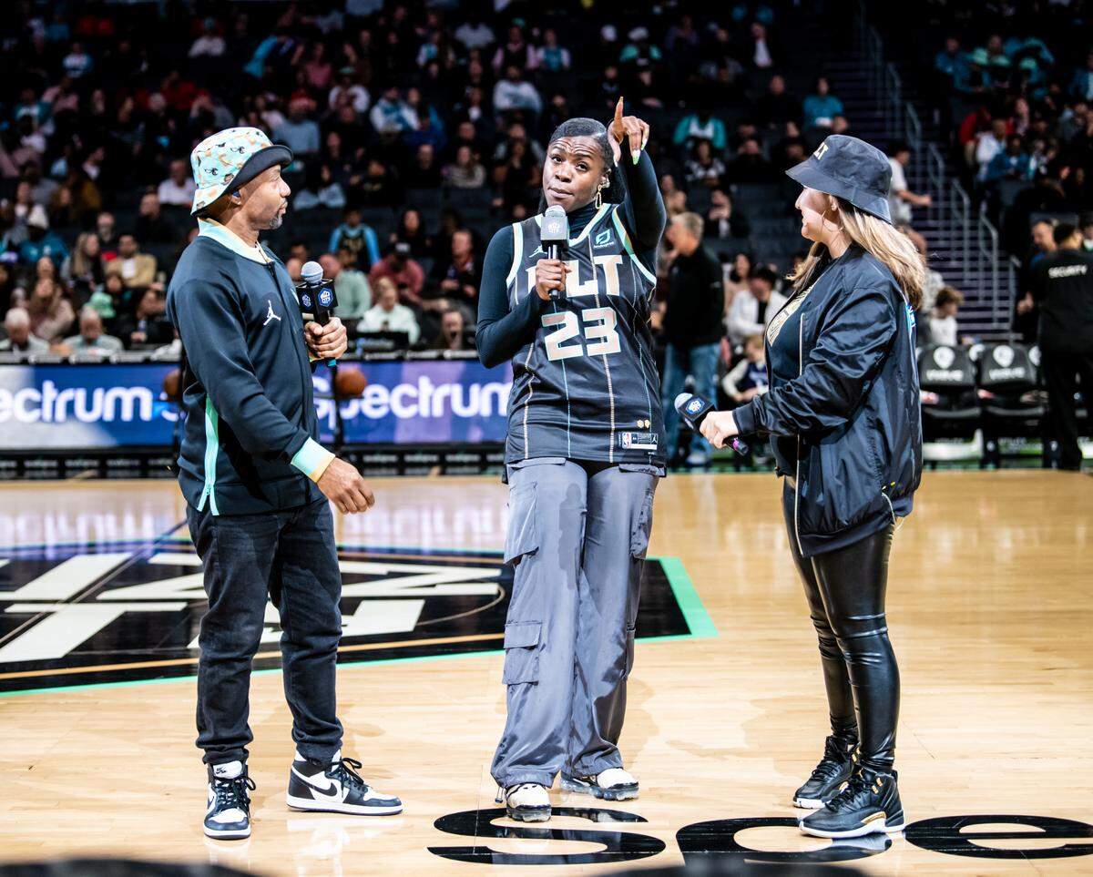 Ohavia, center, with fellow Charlotte Hornets in-arena co-hosts Jacinda Garabito (at right) and Derrick “Fly Ty” Jacobs at a game last season.