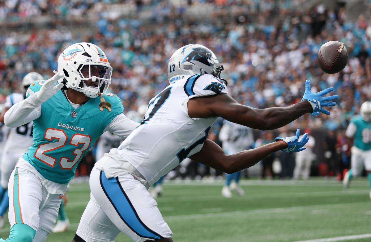Carolina Panthers wide receiver Xavier Legette (17) makes a touchdown catch during the second quarter with Miami Dolphins cornerback Jack Jones (23) defending on Sunday at Bank of America Stadium.