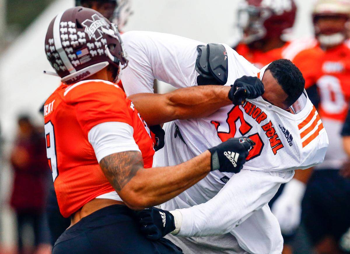 South offensive tackle Tytus Howard of Alabama State (58) loses his helmet in a drill with South defensive end Montez Sweat of Mississippi State (9) during practice for Saturday’s Senior Bowl college football game, Tuesday, Jan. 22, 2019, in Mobile, Ala. (AP Photo/Butch Dill)