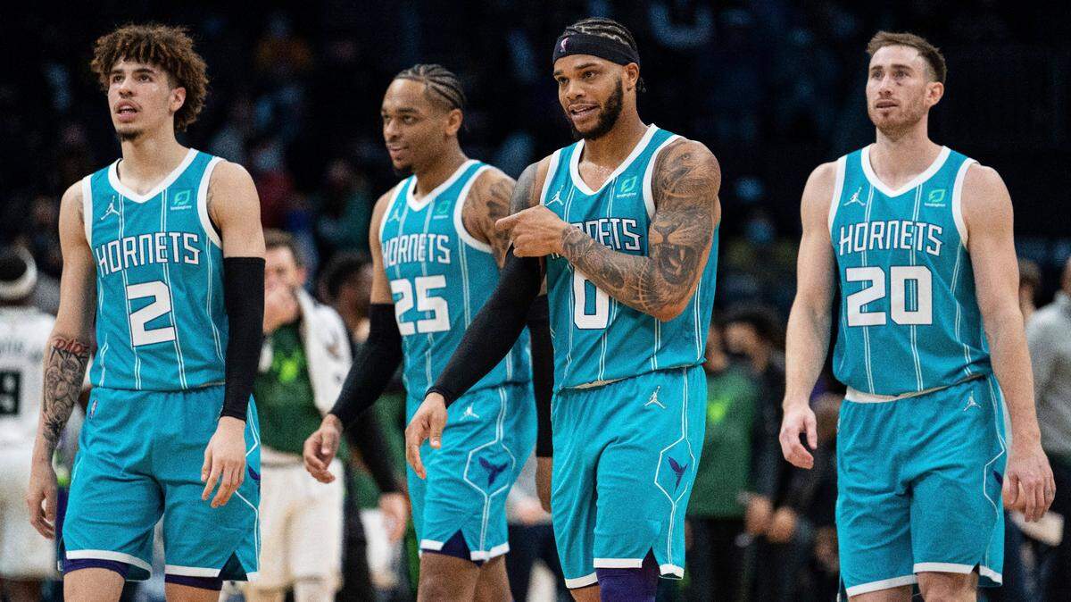 From left to right, Charlotte Hornets guard LaMelo Ball, forwards P.J. Washington, Miles Bridges and Gordon Hayward walk to the bench during the second half of an NBA basketball game against the Milwaukee Bucks in Charlotte, N.C., Monday, Jan. 10, 2022. (AP Photo/Jacob Kupferman)