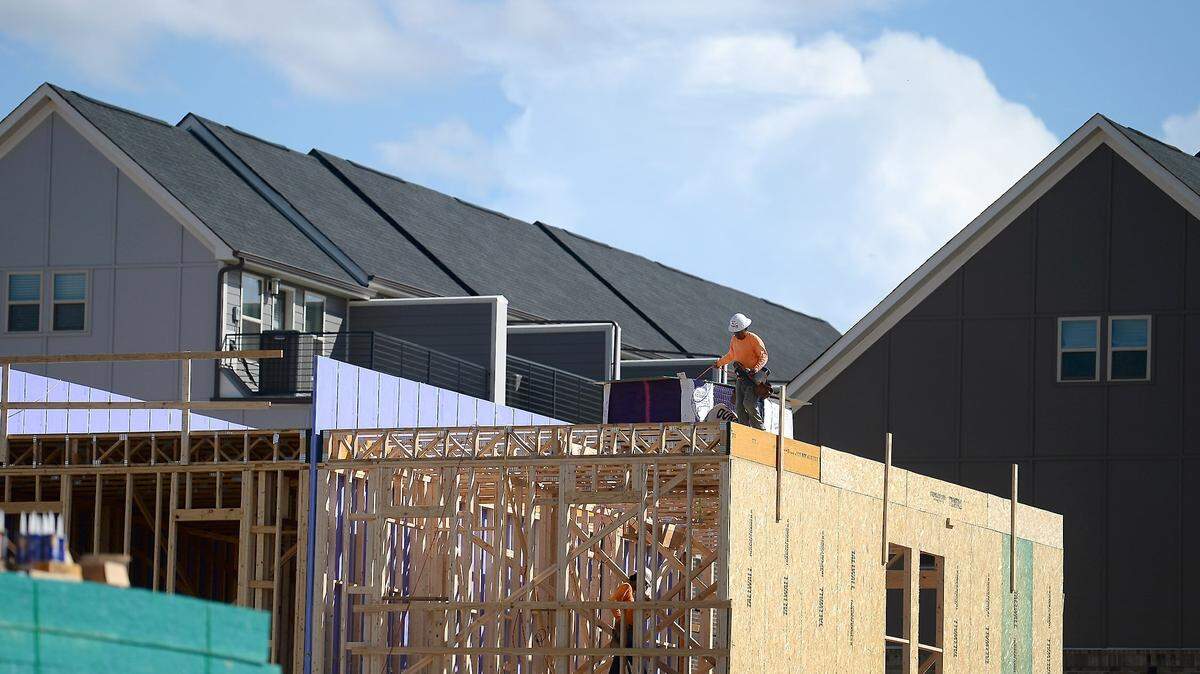 Construction workers work on a section of Pulte Homes along Siegle Avenue in Charlotte, NC on Thursday, July 8, 2021.