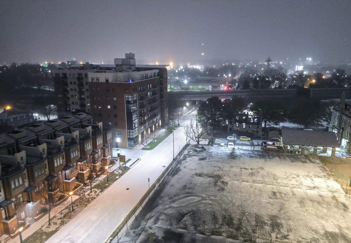 Rain and sleet that moved into the area overnight creates a thin wintry blanket over Uptown Charlotte early Sunday morning on January 25, 2026. 
