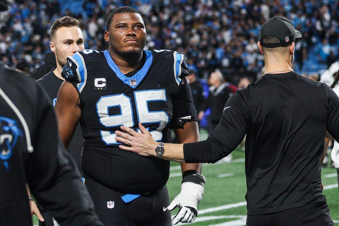 Panthers defensive tackle Derrick Brown receives a pat from head coach Dave Canales as he runs off the field after a loss to the Rams, 34-31, in the Wild Card playoff game at Bank of America Stadium in Charlotte on Saturday, January 10, 2026.