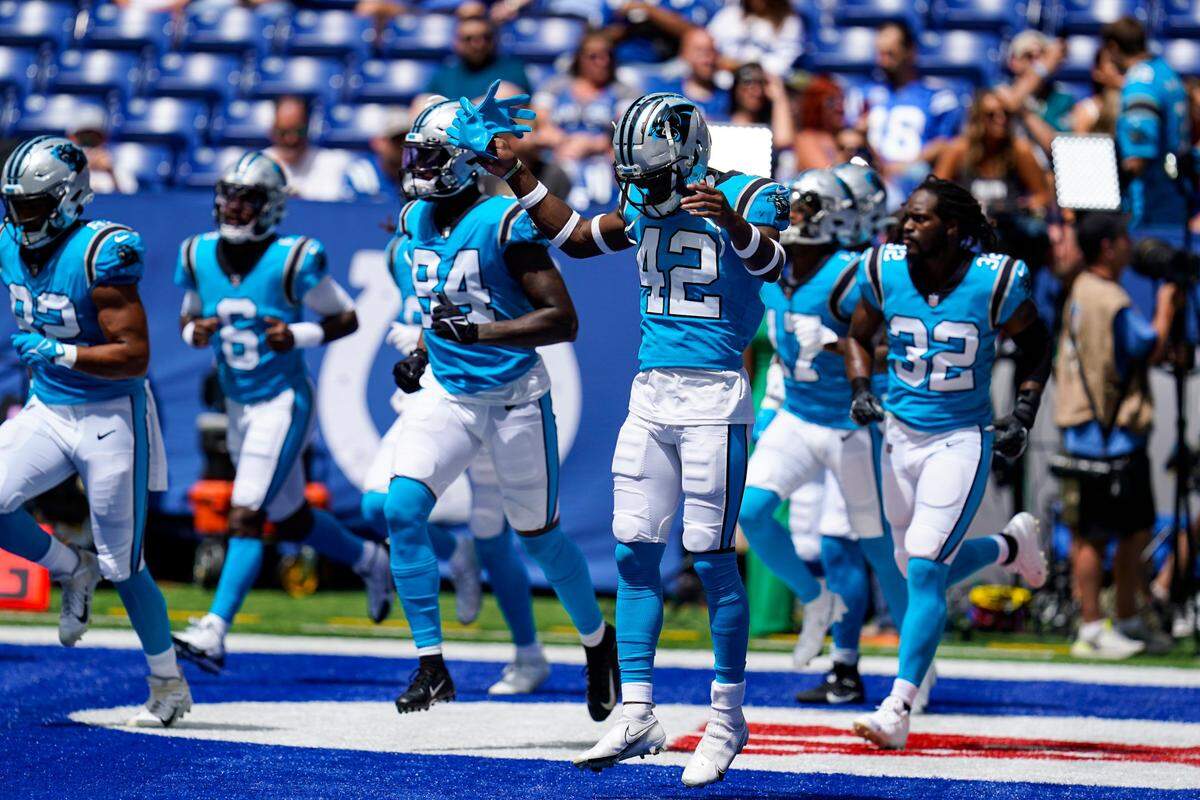 Carolina Panthers safety Sam Franklin (42) and the rest of the tam take the field before an NFL exhibition football game against the Indianapolis Colts in Indianapolis, Sunday, Aug. 15, 2021. (AP Photo/Michael Conroy)