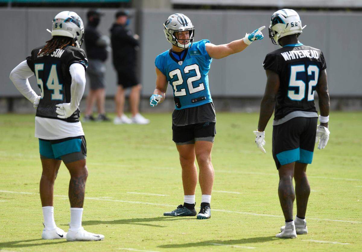 Carolina Panthers running back Christian McCaffrey (22) works with linebacker Shaq Thompson (54) and linebacker Tahir Whitehead (52) during Carolina Panthers Training Camp at the team’s training facility on Sunday, August 16, 2020.