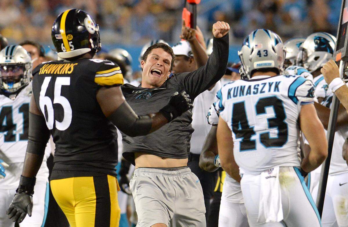 Carolina Panthers linebacker Luke Kuechly, (center) got very excited when linebacker Jordan Kunaszyk, right, made an acrobatic interception in the final preseason game. Two days later, the Panthers told Kunaszyk he had made the team’s initial 53-man roster.