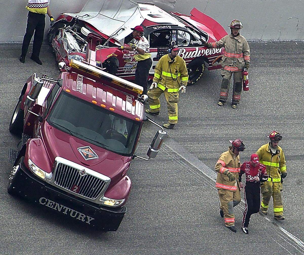 02/25/01: Members of the NASCAR crash crew assist NASCAR driver Dale Earhardt, after he crashed on the first lap of the Dura-Lube 400, Sunday afternoon February 25, 2001, at the North Carolina Motor Speedway, in Rockingham, NC. PATRICK SCHNEIDER/STAFF