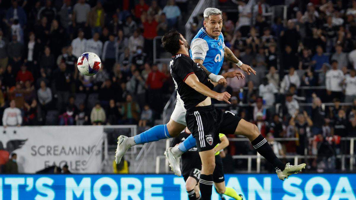 Charlotte FC forward Enzo Copetti (9) and D.C. United defender Steve Birnbaum (15) leap to head the ball in the first half at Audi Field. Geoff Burke-USA TODAY Sports