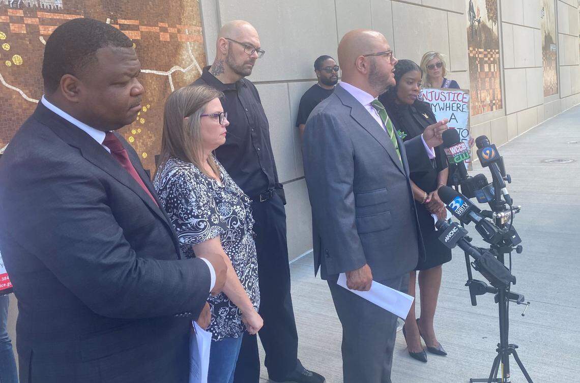 Attorney Chase Lynch speaks during a news conference on Tuesday, Aug. 9, 2022, to announce a federal lawsuit against the City of Concord and its police department for the fatal shooting of Brandon Combs. Attorney Harry Daniels, left, and Combs’ mother, Virginia Tayara, second from left, also spoke.