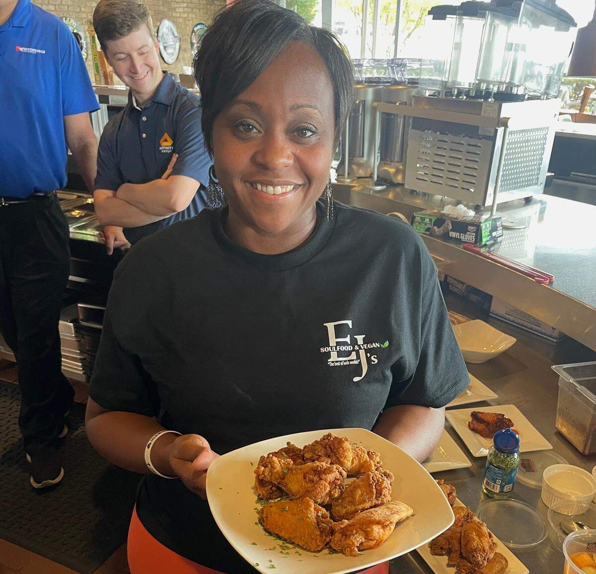 Dara J. Bess, owner of EJs Soul Food and Vegan, holding one of her specialties, fried chicken. 