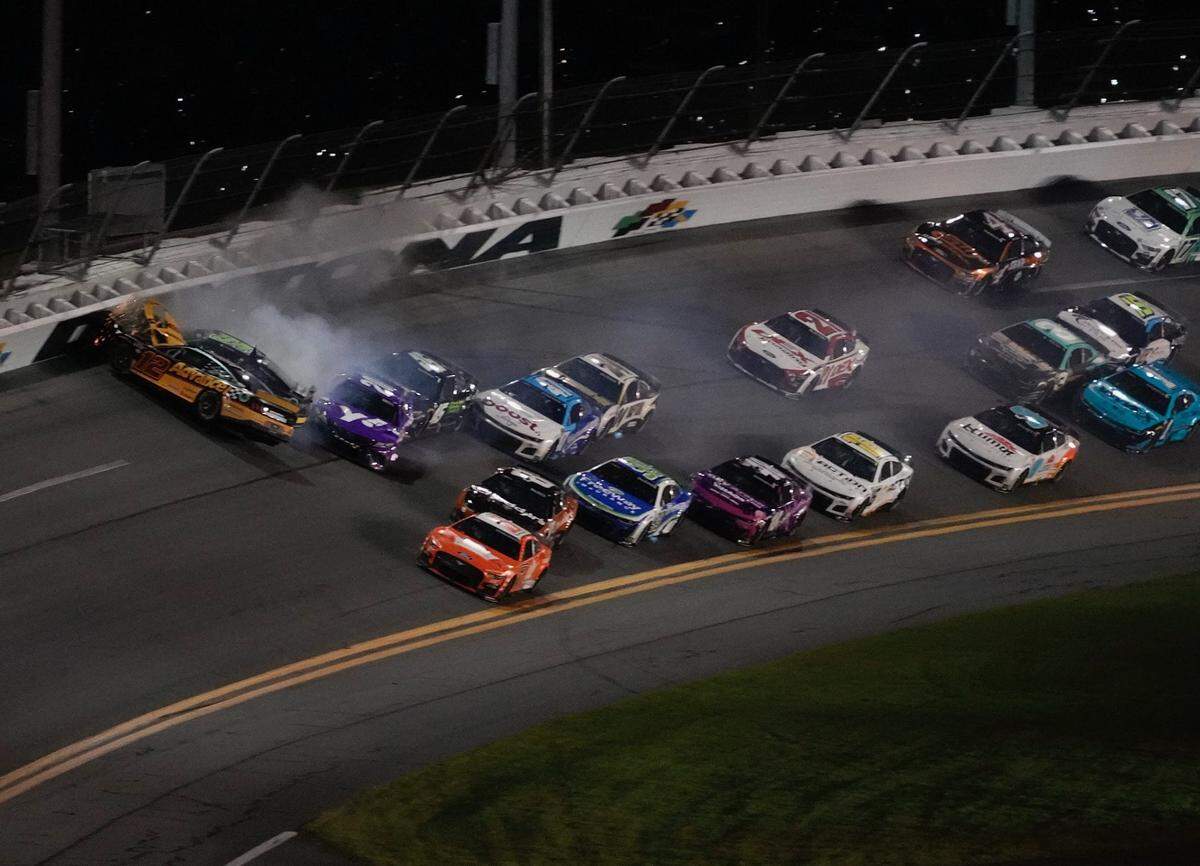 Ryan Blaney (12) is turned nose-first into the wall after contact from Ty Gibbs (54), setting off a massive collision at the end of Stage 2 on Saturday in the Coke Zero Sugar 400 at Daytona.