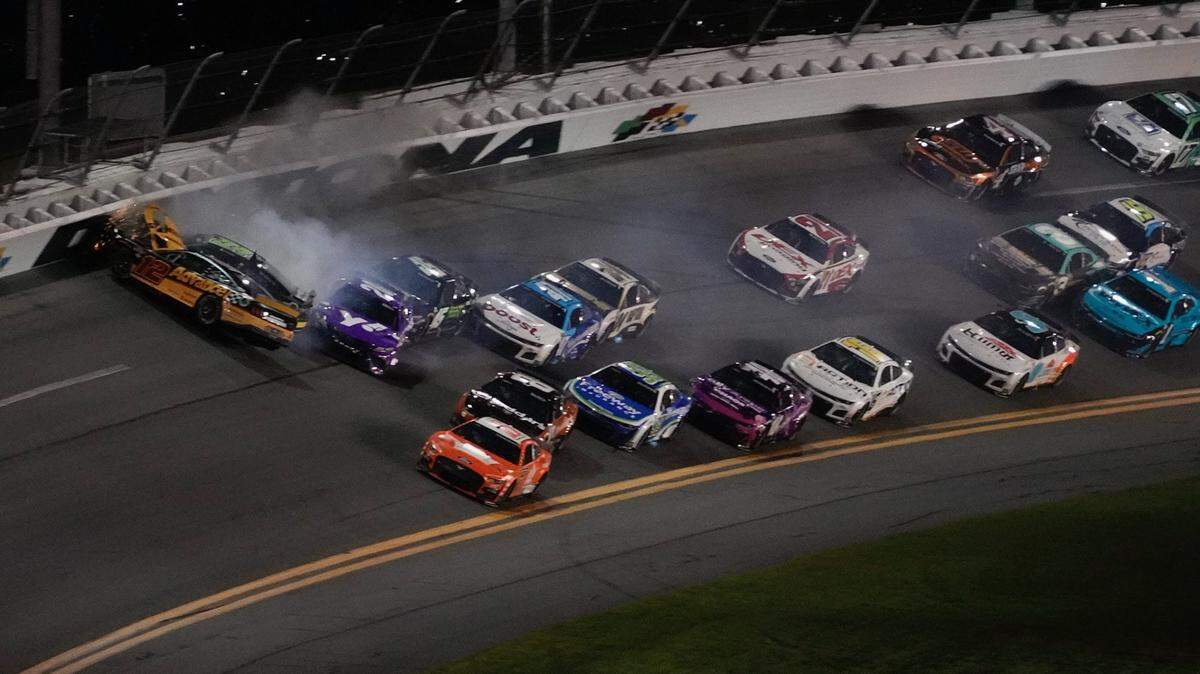 Ryan Blaney (12) is turned nose-first into the wall after contact from Ty Gibbs (54), setting off a massive collision at the end of Stage 2 on Saturday in the Coke Zero Sugar 400 at Daytona.