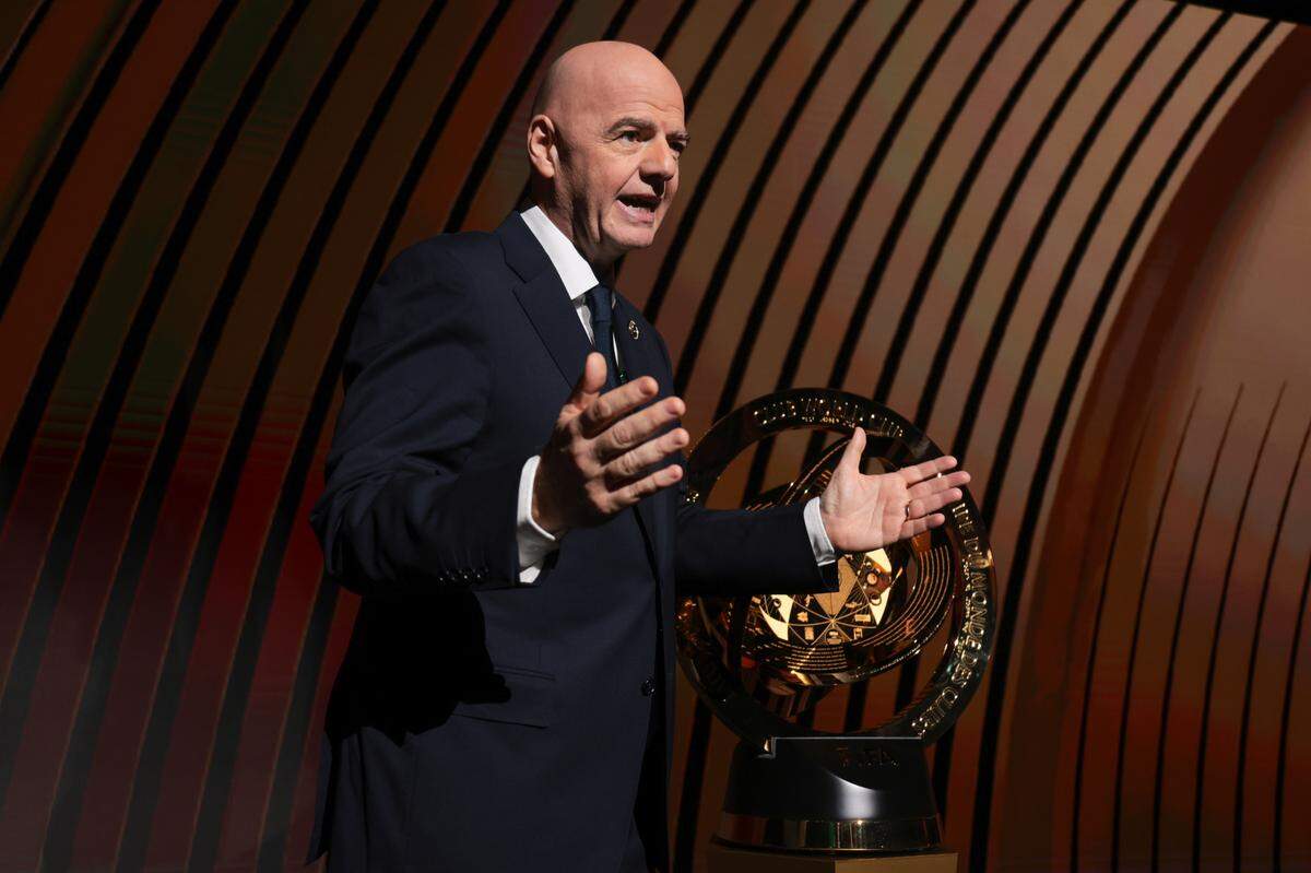 FIFA president Gianni Infantino speaks in front of the 2025 FIFA Club World Cup trophy in Miami.