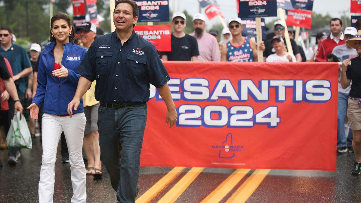 Republican presidential candidate and Florida Gov. Ron DeSantis and his wife Casey, walk in the 2023 July Fourth parade in Merrimack, N.H.