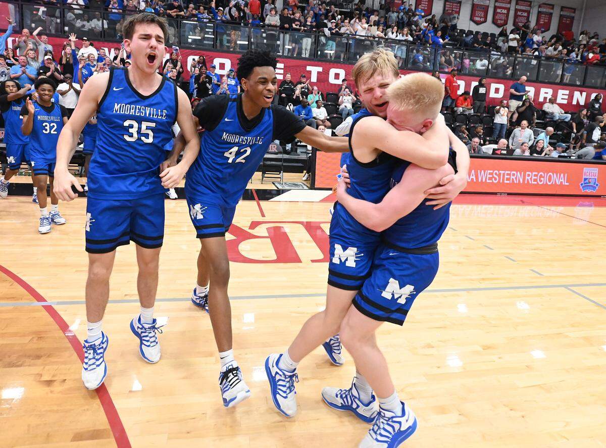 Members of the Mooresville basketball team celebrate their 55-52 win over North Meck in the boy’s 7A NCHSAA regional championship game at Lenoir-Rhyne University in Hickory, NC on Friday, March 6, 2026.