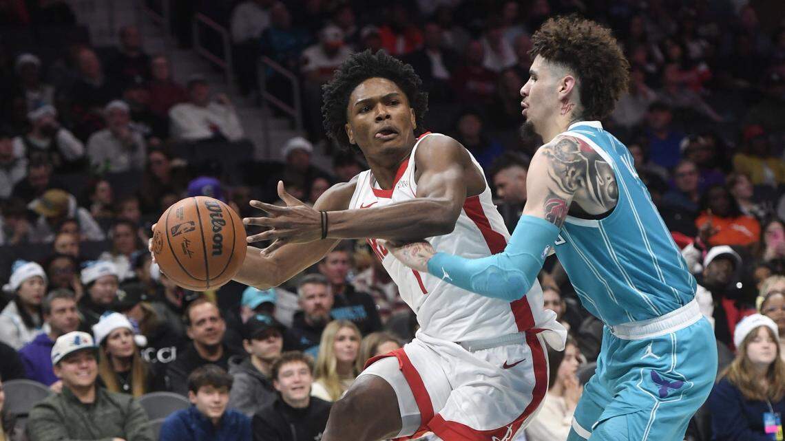 Houston Rockets guard forward Amen Thompson (1) looks to pass through the defense of Charlotte Hornets LaMelo Ball (1) during the second half at the Spectrum Center.