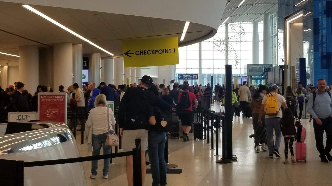 Passengers wait in line at a security checkpoint at Charlotte Douglass International Airport. Officials are preparing for a busy Thanksgiving holiday season.