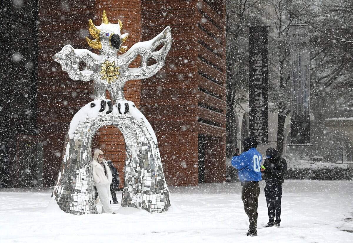 The Firebird outside the Bechtler Museum of Modern Art in uptown Charlotte, NC provides the framing for photographs as an evening snow falls on Saturday, January 31, 2026.