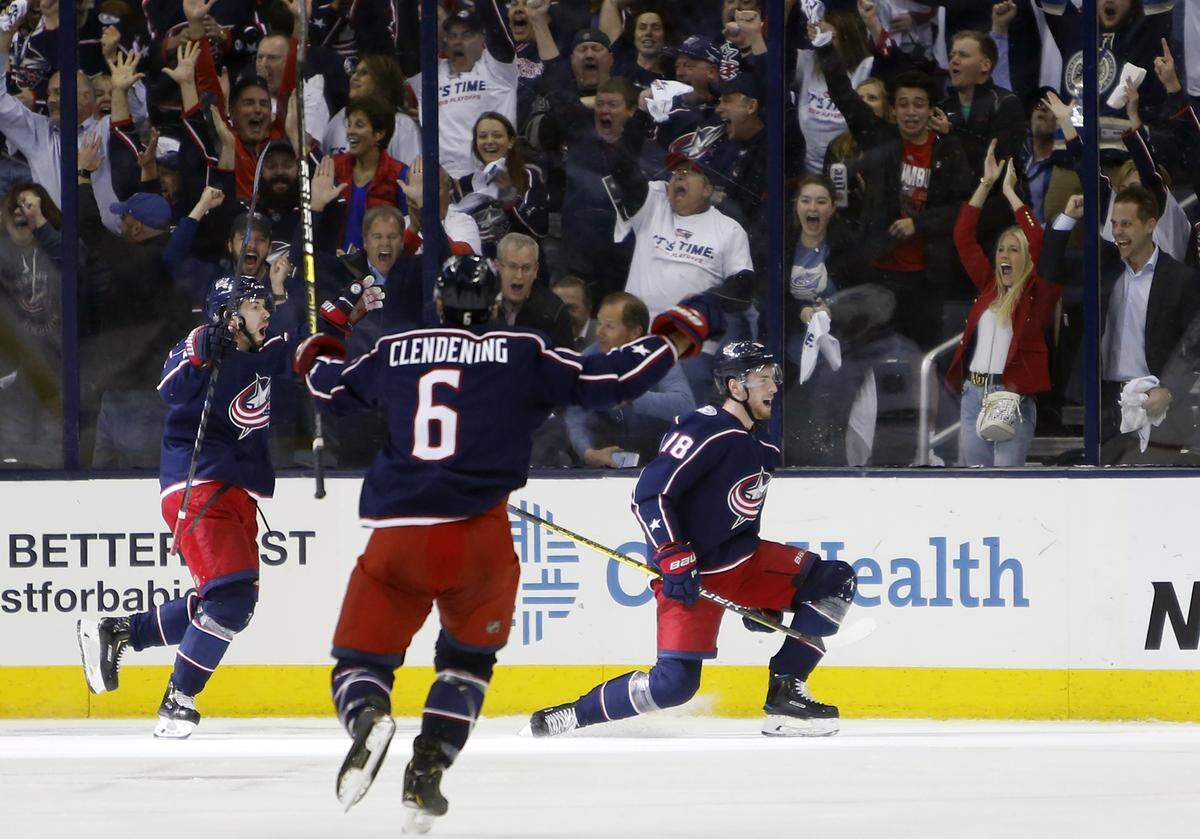 Columbus Blue Jackets’ Pierre-Luc Dubois, right, celebrates his goal against the Tampa Bay Lightning with teammates Oliver Bjorkstrand, left, of Denmark, and Adam Clendening during the first period of Game 4 of an NHL hockey first-round playoff series, Tuesday, April 16, 2019, in Columbus, Ohio. (AP Photo/Jay LaPrete)