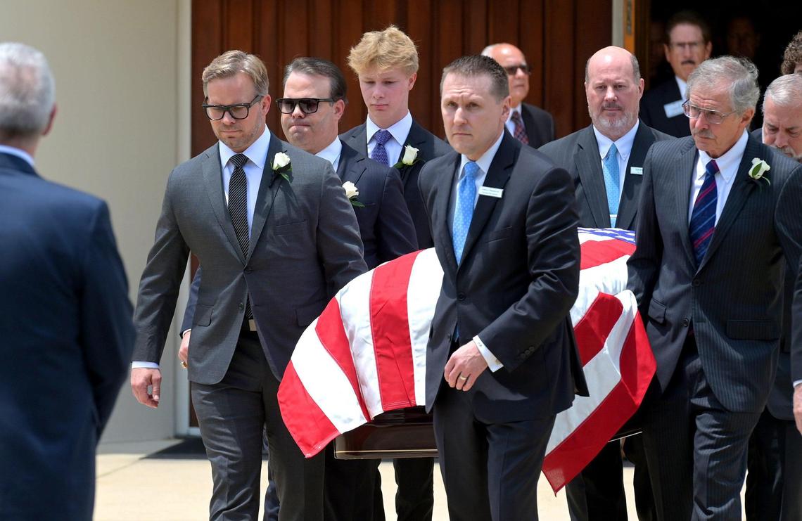 Marcus Smith, front/left and his brother David Smith, behind, help carry their father Bruton Smith’s casket to a hearse following his funeral service at Central Church in Charlotte, NC on Thursday.