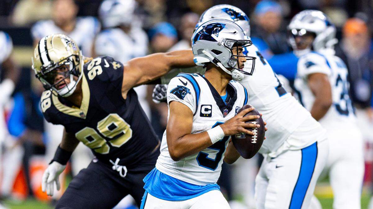 Carolina Panthers quarterback Bryce Young (9) scrambles to make a pass as New Orleans Saints defensive end Chase Young (99) rushes at him during the second half at Caesars Superdome.