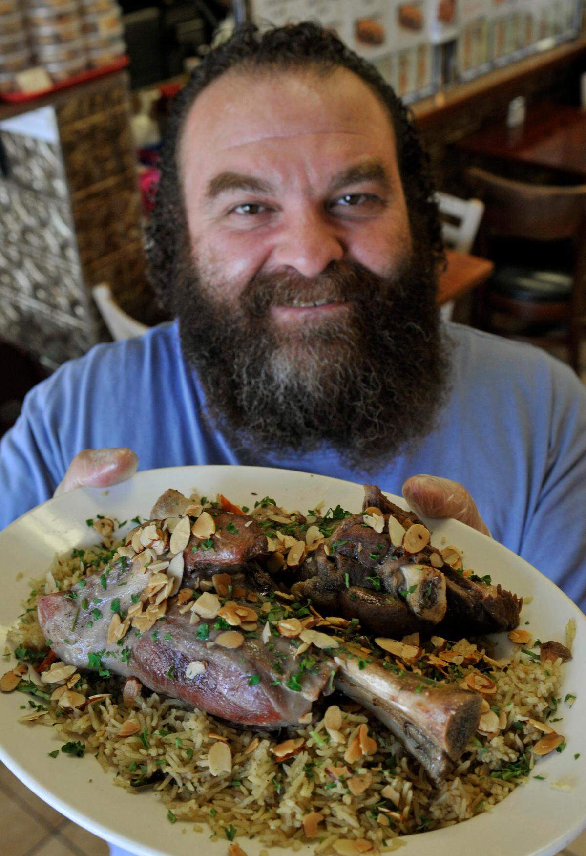 Izzat Freitekh, owner of La Shish Kabob, 3117 N. Sharon Amity Road with his popular lamb shank dinner. __Davie Hinshaw - dhinshaw@charlotteobserver.com
