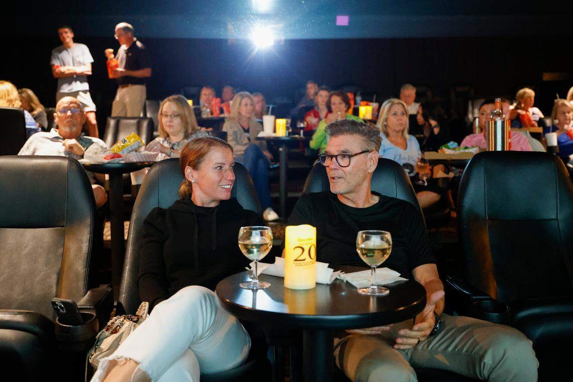 Erin Evernham, left, and Ray Evernham, both of Davidson, N.C., talk before previews start for “Elvis” at Our Town Cinemas in Davidson, Thursday, June 23, 2022.