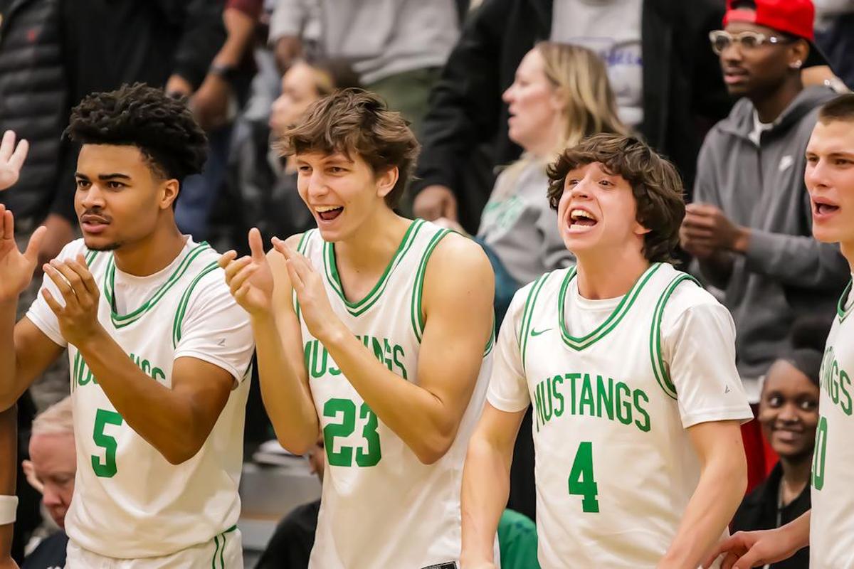 Myers Park Players Bram Early AJ Jamison and Adam Barnes cheer on their team from the sidelines as they take the lead in the first quarter at the NCHSAA 4A state quarterfinals At Myers Park highschool