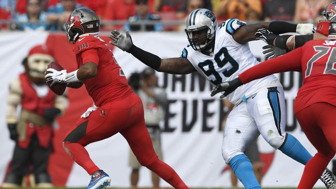 Tampa Bay Buccaneers quarterback Jameis Winston (3) scrambles out of the reach of Carolina Panthers defensive tackle Kawann Short (99) during the first half of their game at Raymond James Stadium on Sunday, December 2, 2018. The Buccaneers won 24-17.