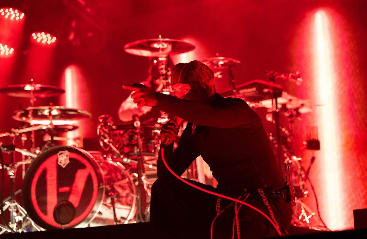 Tyler Joseph of Twenty One Pilots performs while wearing one of two different masks he put on at PNC Music Pavilion in Charlotte on Thursday (although for most of the night, his face was in full view).